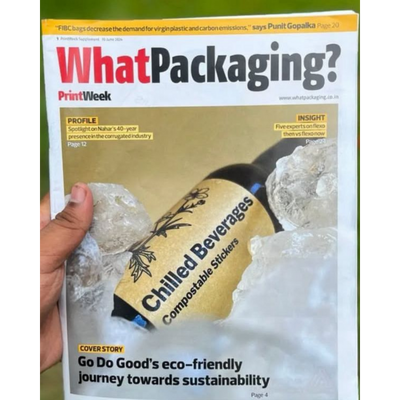 Magazine cover titled 'What Packaging?' featuring a bottle with compostable stickers.
